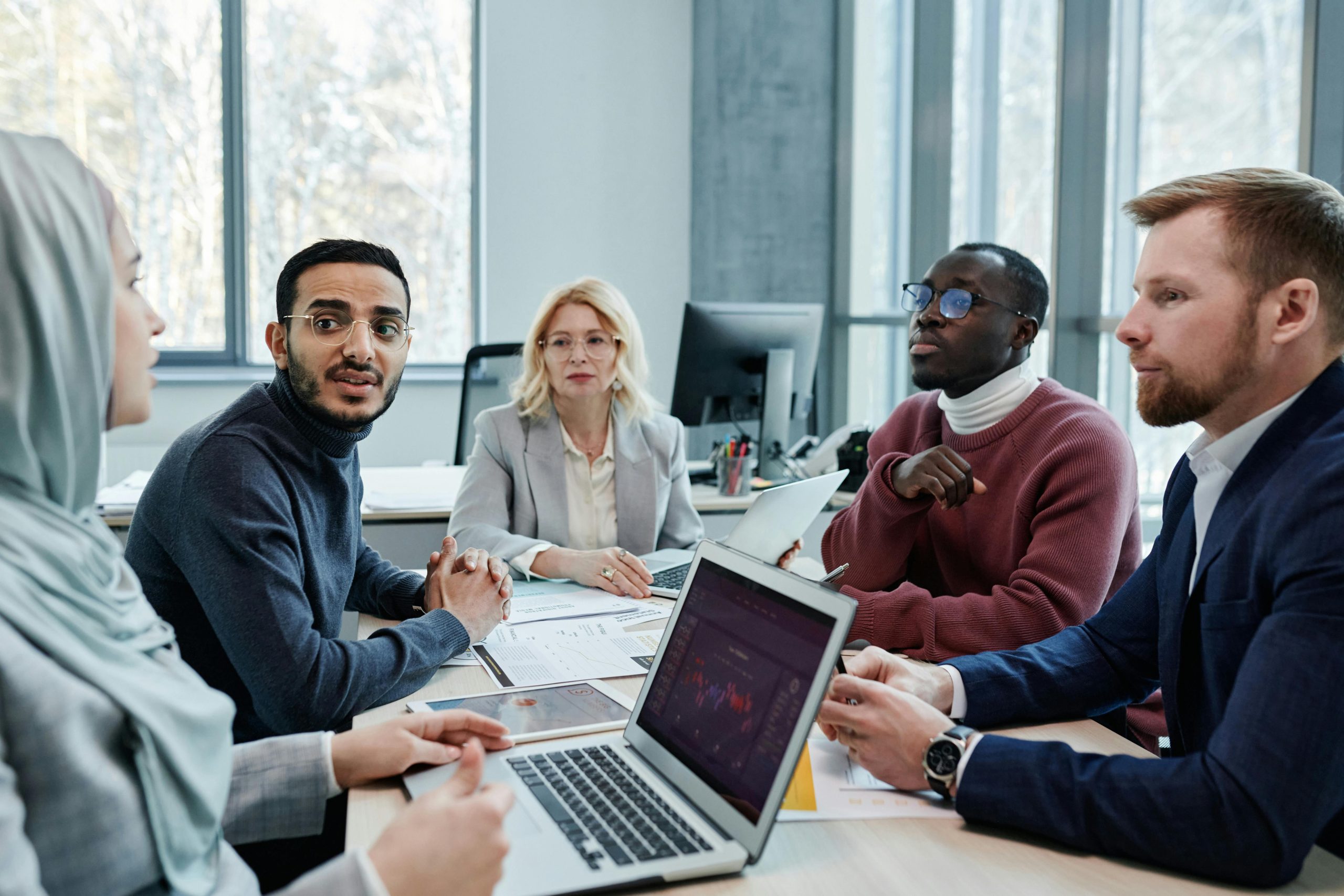 Diverse team in a meeting discussing company goals.