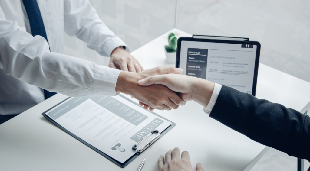 Employer shaking hands with a candidate after an interview.