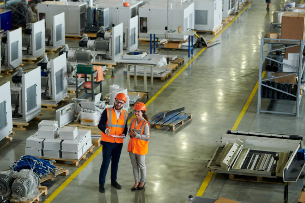 Manager leading a workplace safety inspection or meeting with a clipboard.