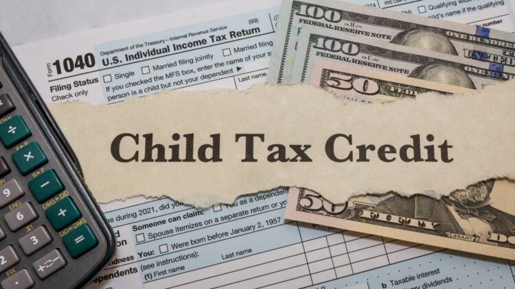 Tax documents and cash illustrating the Child Tax Credit update.