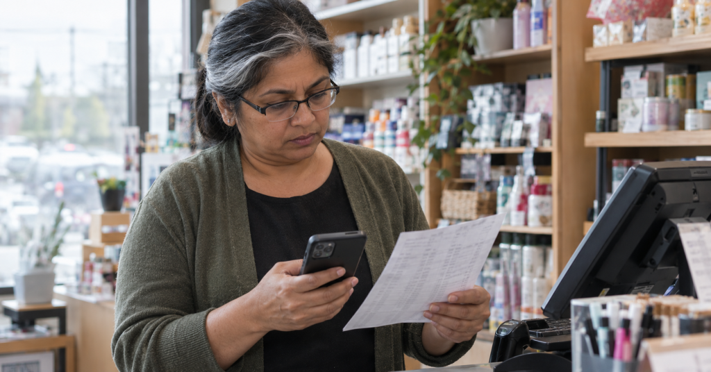 Small business owner checking employee pay rates against the 2027 minimum wage checklist